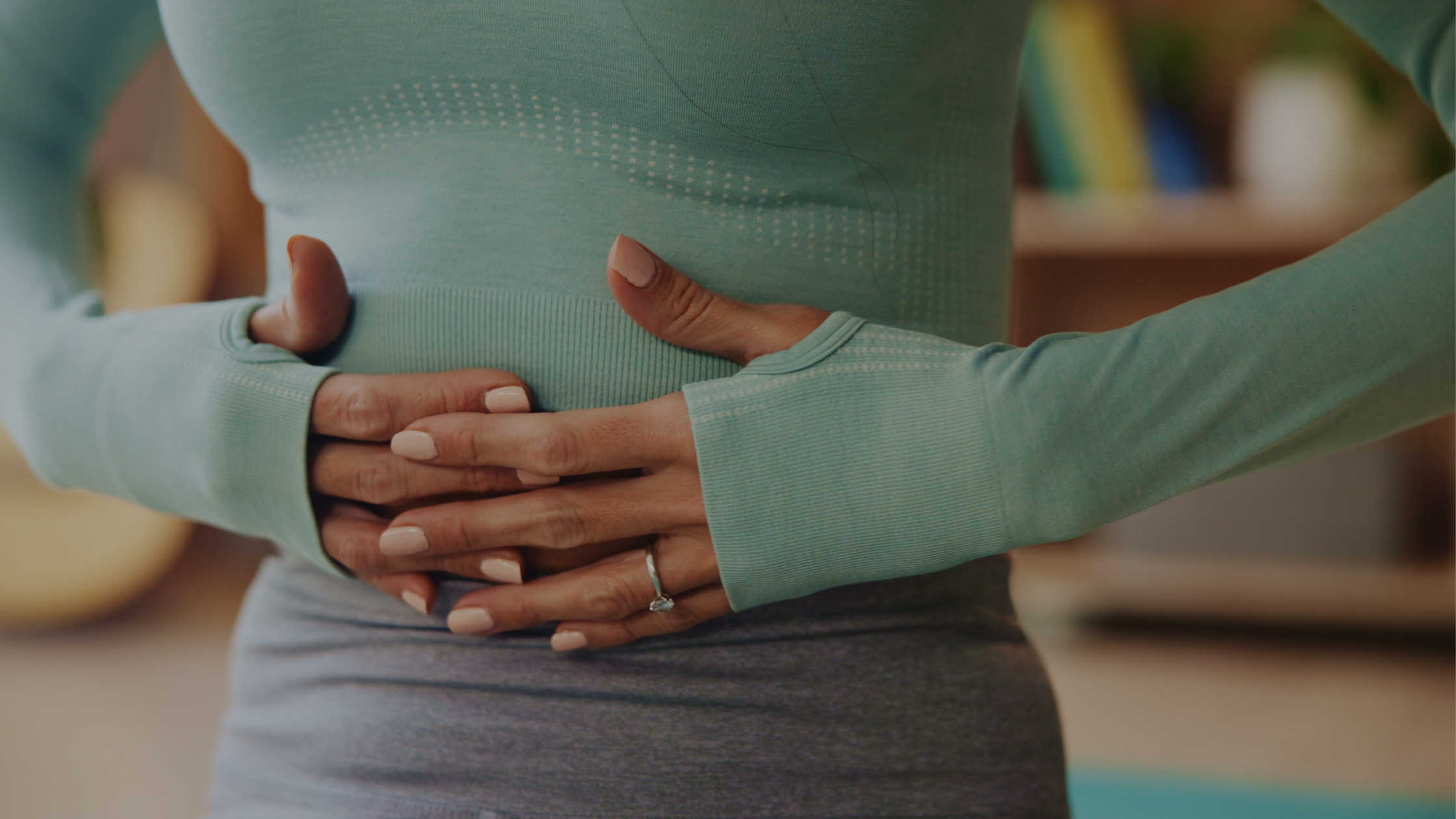 A woman with her hands on her tummy area